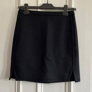 Jcrew 100% wool black mini skirt with two notches, size 0. Polyester lined.